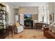 Living room featuring hardwood floors, a fireplace, and natural light through large windows at 16211 Villarreal De Avila, Tampa, FL 33613