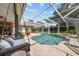 A covered pool area with a pool swing, outdoor seating, and a screened enclosure at 16211 Villarreal De Avila, Tampa, FL 33613