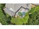Aerial view of a screened in pool with a well manicured backyard with palm trees at 16211 Villarreal De Avila, Tampa, FL 33613