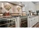Stylish wet bar with wine refrigerators, decorative backsplash, granite countertop and under-cabinet lighting at 16211 Villarreal De Avila, Tampa, FL 33613