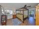 Main bedroom featuring a four-poster bed, ceiling fan, and natural lighting at 1707 Wedge Ct, Sun City Center, FL 33573