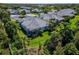 Aerial view of a beautiful backyard with a screened lanai, surrounded by lush green landscaping at 1806 Lake George Cv, Bradenton, FL 34211