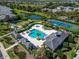 A bird's eye view showcases a community area with a pool, spa, and tennis courts at 1806 Lake George Cv, Bradenton, FL 34211