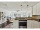 This kitchen opens up to the living area with stainless appliances and granite counters at 1828 Barbara Ln, Clearwater, FL 33755