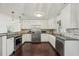 This kitchen features granite counters, stainless appliances, a stainless refrigerator and light backsplash at 1828 Barbara Ln, Clearwater, FL 33755