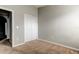 Cozy bedroom featuring neutral walls and flooring, doors, and electrical outlets at 2039 Strathmill Dr, Clearwater, FL 33755