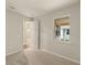 Bedroom featuring neutral walls, plush carpeting, and a bright window with a pleasant view at 20411 Symphony Pl, Venice, FL 34293
