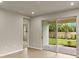 Bright living room with sliding glass doors opening to a patio and landscaped backyard at 20411 Symphony Pl, Venice, FL 34293