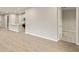 Open living space features wood-look flooring and an adjacent kitchen at 20411 Symphony Pl, Venice, FL 34293