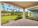 Spacious patio overlooking well-manicured backyard, perfect for outdoor entertaining and relaxation at 20411 Symphony Pl, Venice, FL 34293
