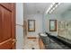 Bathroom featuring a framed mirror, a glass-enclosed shower, marble floors, and plenty of cabinet space at 2053 N Pointe Alexis Dr, Tarpon Springs, FL 34689