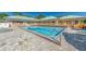 Community pool and clubhouse with ample deck space for lounging at 2053 N Pointe Alexis Dr, Tarpon Springs, FL 34689