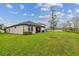 Lush green backyard with a well-maintained lawn extending to the rear of the home at 21577 Violet Periwinkle Dr, Land O Lakes, FL 34637