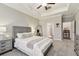 Bedroom with tray ceiling with grey furniture, and doorway to bathroom at 21577 Violet Periwinkle Dr, Land O Lakes, FL 34637