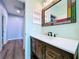 The bathroom features a rustic wood vanity with a white countertop at 2204 Margaret Way, Dunedin, FL 34698