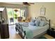 Bright bedroom with access to patio and features comfortable decor and textiles at 2205 Belleair Rd # A7, Clearwater, FL 33764