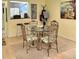Cozy dining area with glass table, ornate chairs, and view to kitchen at 2205 Belleair Rd # A7, Clearwater, FL 33764
