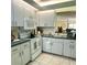 Kitchen with white cabinets, dark countertops, and essential appliances at 2205 Belleair Rd # A7, Clearwater, FL 33764