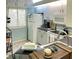 Bright kitchen features white cabinets, countertops, and appliances near window at 2205 Belleair Rd # A7, Clearwater, FL 33764