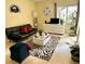 Bright living room features a black futon, patterned rug, and white furniture at 2205 Belleair Rd # A7, Clearwater, FL 33764