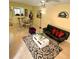 Bright living room with ceiling fan, black sofa with red pillows, and adjacent dining area with round glass table at 2205 Belleair Rd # A7, Clearwater, FL 33764
