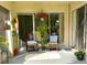Enclosed patio offers seating with views through sliding glass doors into the living space, with plants for added appeal at 2205 Belleair Rd # A7, Clearwater, FL 33764