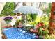Serene patio features a leafy umbrella, cushioned seating, and lush landscaping, creating a relaxing outdoor retreat at 2205 Belleair Rd # A7, Clearwater, FL 33764