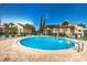Community swimming pool surrounded by brick pavers, lounge chairs, and well-maintained landscaping for resident enjoyment at 2205 Belleair Rd # A7, Clearwater, FL 33764