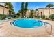 Community pool includes chairs, palm trees, and nearby residential buildings, providing a serene and convenient amenity at 2205 Belleair Rd # A7, Clearwater, FL 33764