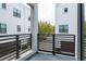 Open air balcony with black metal railings overlooking a street of modern townhomes at 224 S Audubon Ave, Tampa, FL 33609