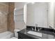 Bathroom with tile surround shower and updated vanity at 224 S Audubon Ave, Tampa, FL 33609