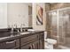 Bathroom featuring granite countertops, a shower, and tiled walls at 224 S Audubon Ave, Tampa, FL 33609