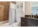 Bathroom with a shower-tub combo, dark vanity, and ample storage at 224 S Audubon Ave, Tampa, FL 33609