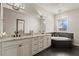Bright bathroom featuring double vanity with granite counters and garden tub under a chandelier at 224 S Audubon Ave, Tampa, FL 33609