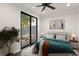 Bright bedroom with a modern aesthetic, featuring a sliding door to a private patio at 224 S Audubon Ave, Tampa, FL 33609