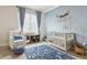 Adorable Bedroom with blue accents, a wooden crib, and a patterned rug at 224 S Audubon Ave, Tampa, FL 33609