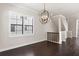 Bright dining room with dark floors, modern light fixture, and large windows, offering a cozy atmosphere at 224 S Audubon Ave, Tampa, FL 33609