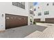 Beautiful white townhomes featuring private garages and stone driveway at 224 S Audubon Ave, Tampa, FL 33609