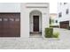 Inviting front entrance with a dark wood door, stone walkway, and manicured landscaping at 224 S Audubon Ave, Tampa, FL 33609