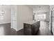 Kitchen island with stone countertops and dark wood cabinets, connecting to the dining and living area at 224 S Audubon Ave, Tampa, FL 33609