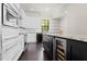 A modern kitchen featuring stainless steel appliances, dark hardwood floors, and sleek cabinetry at 224 S Audubon Ave, Tampa, FL 33609