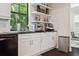 Well-lit kitchen features modern appliances, white cabinets, and a black countertop at 224 S Audubon Ave, Tampa, FL 33609