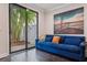 Cozy living room with a blue sofa, modern art, and sliding doors to the outdoors at 224 S Audubon Ave, Tampa, FL 33609