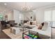 Elegant living room with a stylish chandelier, plush seating, and decorative area rug at 224 S Audubon Ave, Tampa, FL 33609