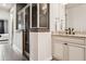 Bathroom featuring a walk-in shower, granite countertops, and dark brown tile accents at 224 S Audubon Ave, Tampa, FL 33609