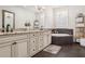 Elegant main bathroom featuring granite countertops, a soaking tub, and decorative shelving at 224 S Audubon Ave, Tampa, FL 33609