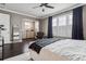 Spacious main bedroom featuring dark wood floors, white walls, and a sitting area at 224 S Audubon Ave, Tampa, FL 33609