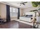 Bright main bedroom with dark wood floors, white accents, and a large window at 224 S Audubon Ave, Tampa, FL 33609