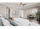 Spacious main bedroom with a ceiling fan, dark hardwood floors, and a comfortable seating area at 224 S Audubon Ave, Tampa, FL 33609
