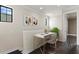 Upstairs landing featuring a modern desk and chair, plus a decorative art and a houseplant at 224 S Audubon Ave, Tampa, FL 33609
